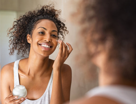 Applying natural face lotion to clean skin