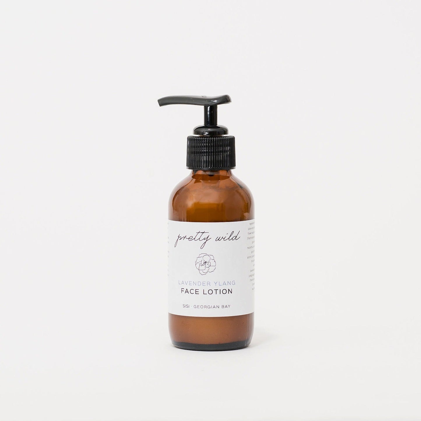 Natural beauty care products - SiSi Georgian Bay "pretty wild" face lotion in an amber glass bottle with a pump top lid on a creamy white background