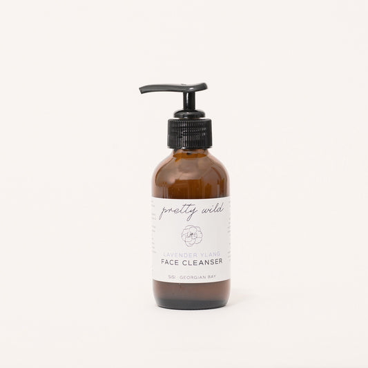 Natural face care product - SiSi Georgian Bay "pretty wild" face cleanser in an amber glass bottle with a pump lid on a creamy white background