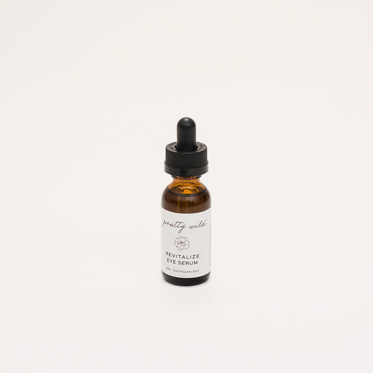 Natural Face Serums - natural skincare products - northern ontario - SiSi Georgian Bay "pretty wild" Revitalize Eye Serum in an apothecary amber glass bottle on a creamy white background