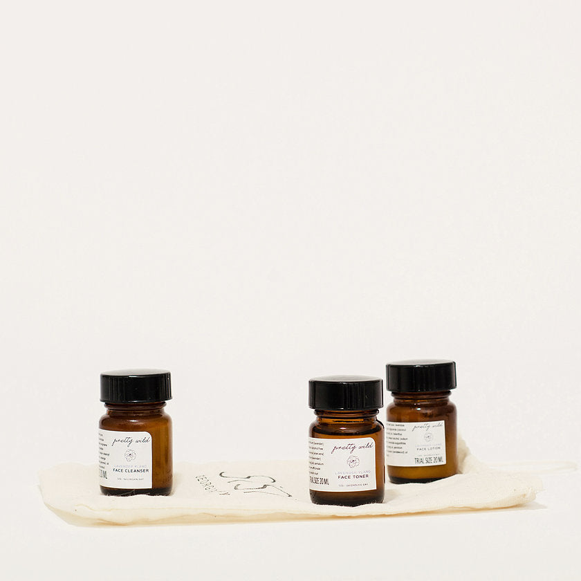 SiSi Georgian Bay natural beauty products in trial size cute amber glass jars, on a muslin carrying bag with a creamy white background